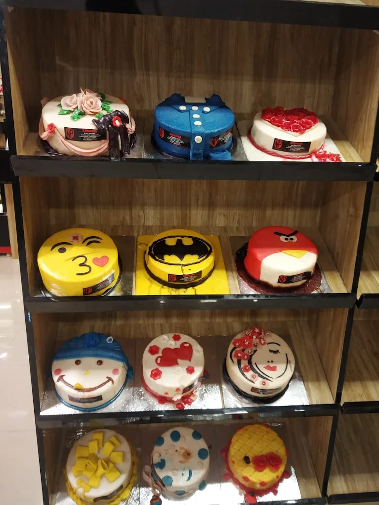 Custom themed cakes — Batman, emoji, character cakes from Narayana Pastries